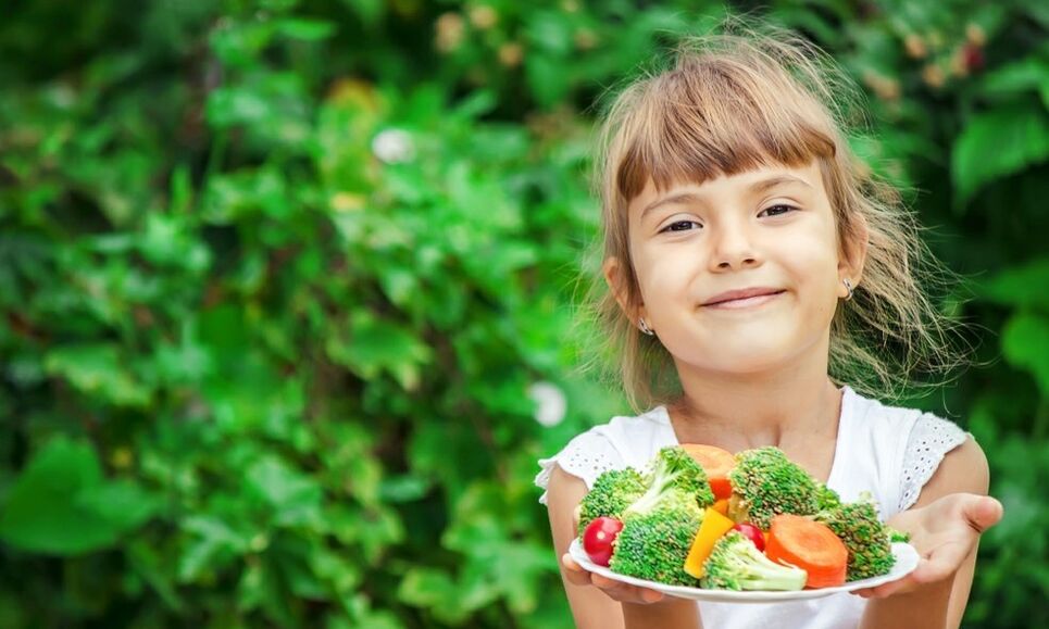 girl with plate of vegetables